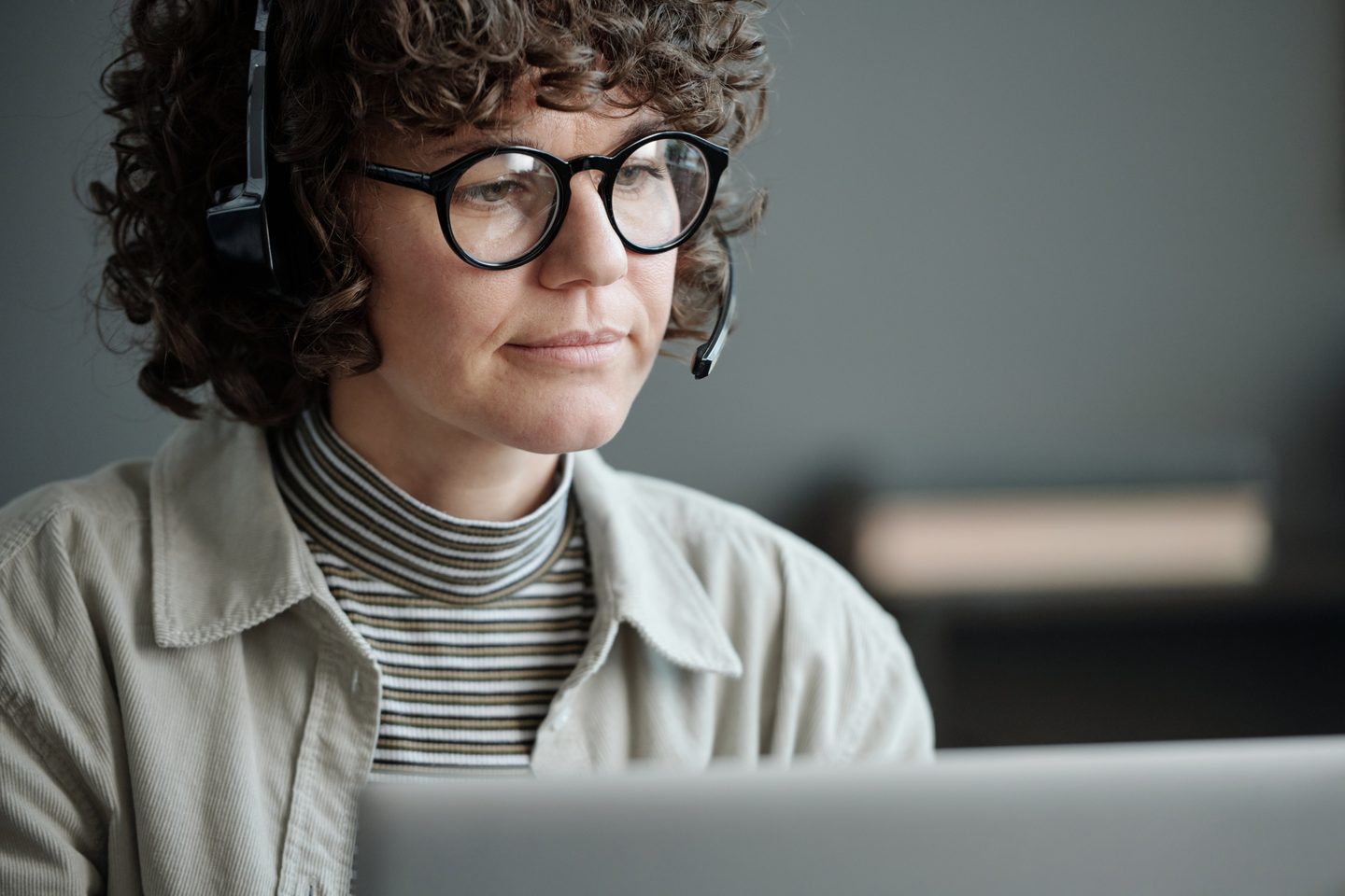 An SDR on a headset working through a call list at a laptop