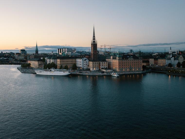 Stockholm waterfront at dusk, seen across the water from Riddarholmen