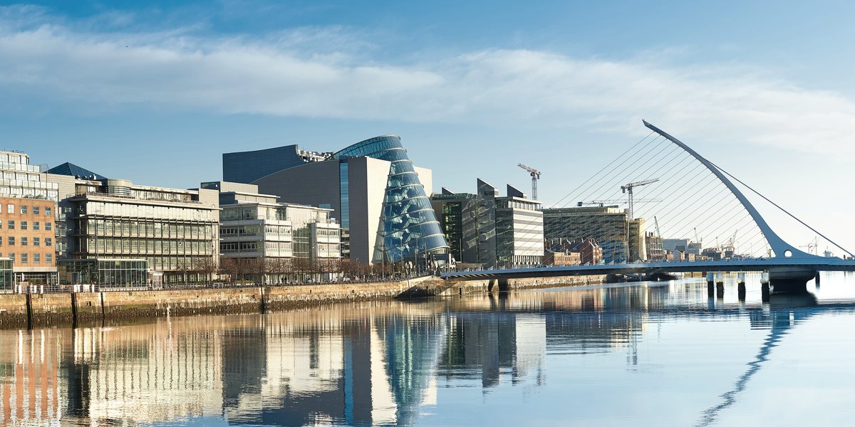 Dublin's docklands reflected in the River Liffey, with the Samuel Beckett Bridge